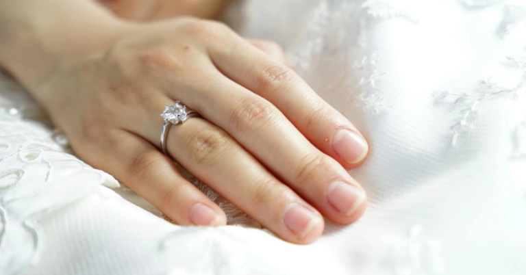 A woman's hand adorned with a wedding ring, symbolizing love and commitment.