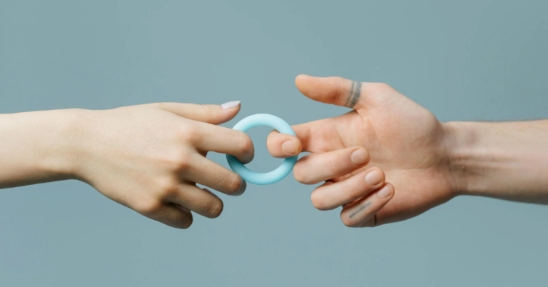 Two people holding hands, showcasing a blue silicone ring, symbolizing love and connection.