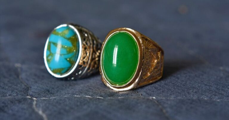 Two elegant rings featuring green and gold stones, symbolizing style and significance in jade jewelry.